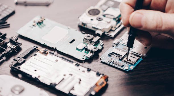 Phone disassembled on the repair bench with precision tools